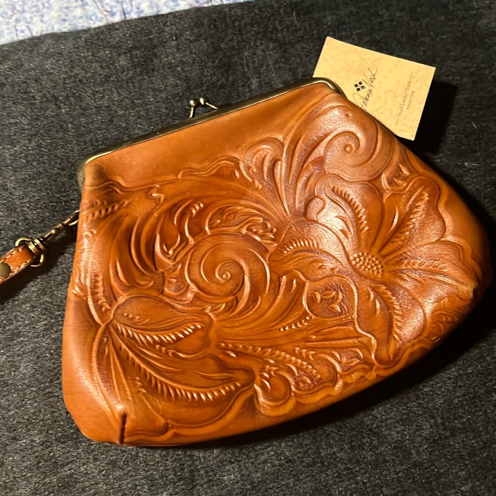 Burnished tooled coin purse style wristlet with strap. Used twice.